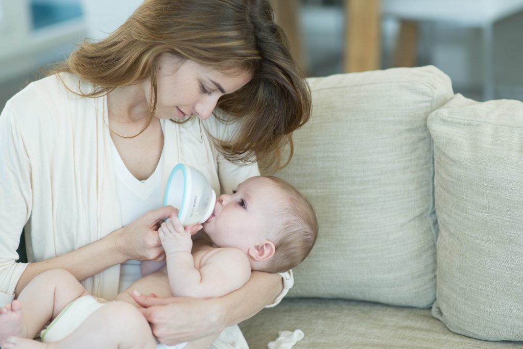 mom feeding baby with nanobebe bottle